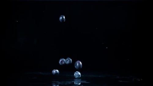 Blueberries Falling in Slow Motion on Wet Surface
