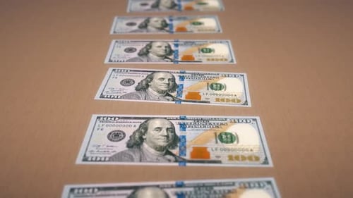 Dollar Bills Arranged In A Row On A Table