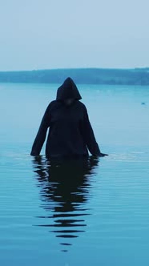 Scary figure in black mantle. Halloween costume Vertical video