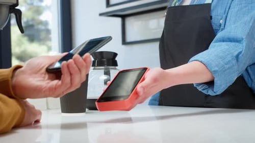 Sale in the Coffee Cafeteria in the Pos Terminal A Man Pays Using a QR Code with a Smartphone
