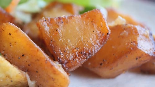 Seasoned Fried Potatoes and Salad Close Up