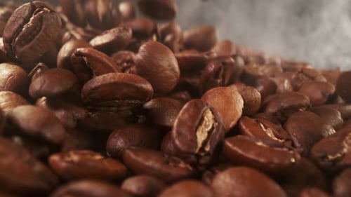 Super Slow Motion Of Falling Coffee Beans With Camera Move. Filmed On High Speed Cinema Camera