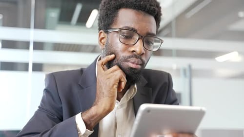 Adult Man Using Tablet in Modern Office