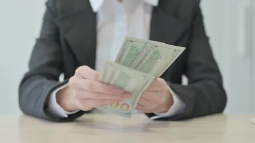 Close up of Businesswoman Counting Dollars
