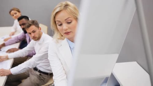 Diverse business team brainstorms at office presentation with flipboard