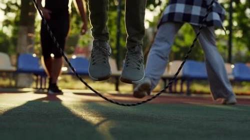 Focused Beautiful Guy Jumping Rope With Naked Body In Sport Playground. Active Sportsman Training...
