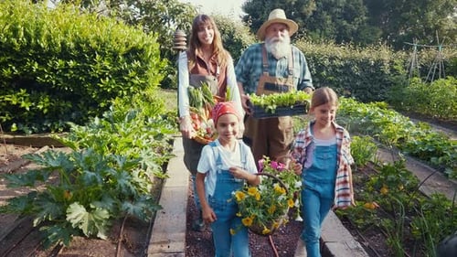 Family Walks Through Lush Garden with Harvest and Flowers