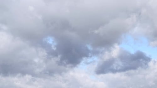 Fluffy Gray Clouds Move Across the Sky