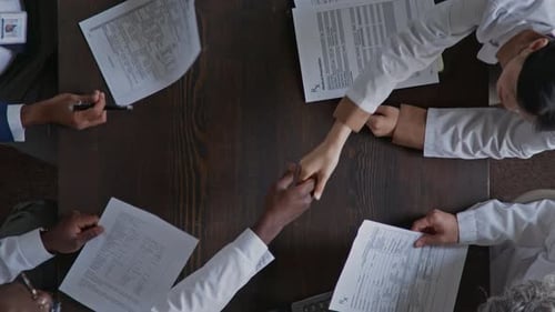Top View of Doctors and Hospital Director Shaking Hands at Meeting