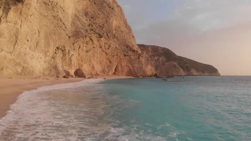Slow motion aerial beautiful beach and water bay in the greek spectacular coast line. Turquoise blue