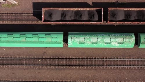 Top View of Fast Moving Train with Green Wagons
