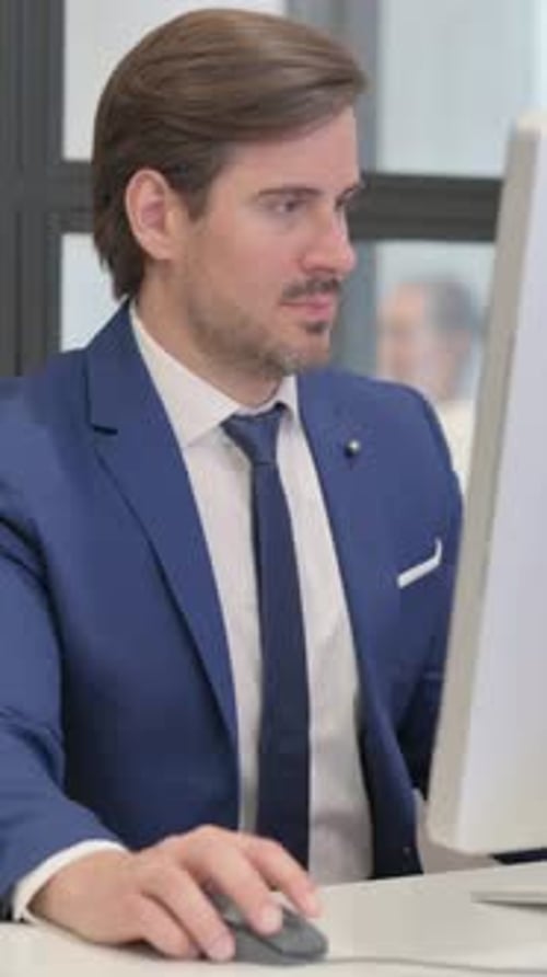 Man in Suit Works at Computer in Office