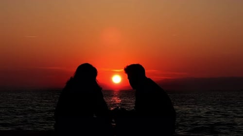 Couple Lovers Silhouette Near The Sea And Sunset