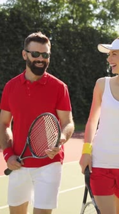 A Joyful and Active Couple Engaging Together in a Fun Game of Tennis on the Court