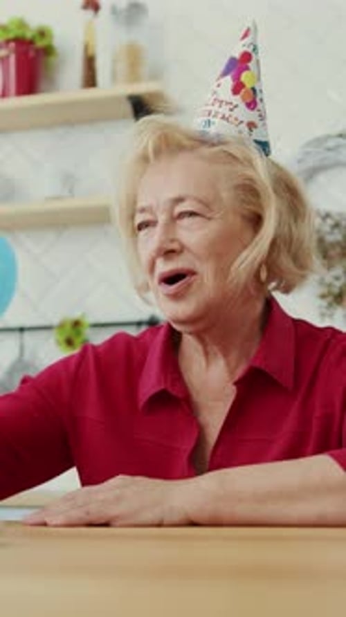 Senior Woman Celebrates Birthday With Champagne