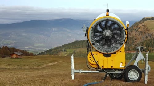 Yellow Snow Cannon in Rural Mountainous Landscape