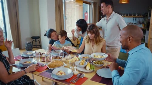 Smiling Family Enjoying Lunch at Home Together
