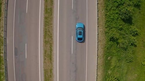 Beautiful automobile on a road. Modern blue electric car moving on a highway.