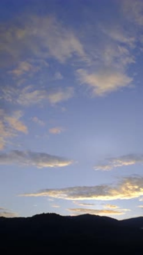 Clouds Drifting in the Sky Above a Mountain