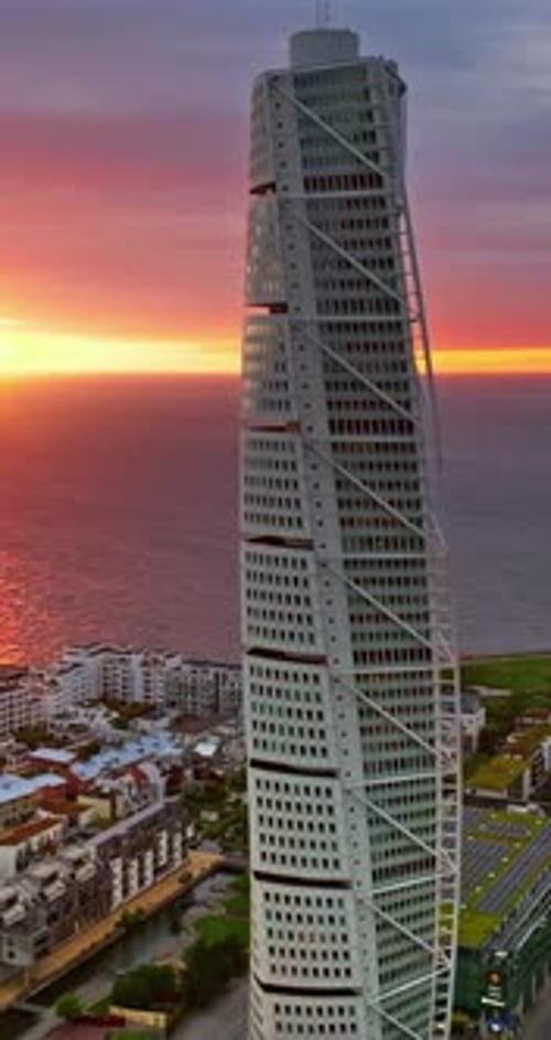 Aerial drone view of Turning Torso residential skyscraper in Malmo, Sweden at sunset. Vertical