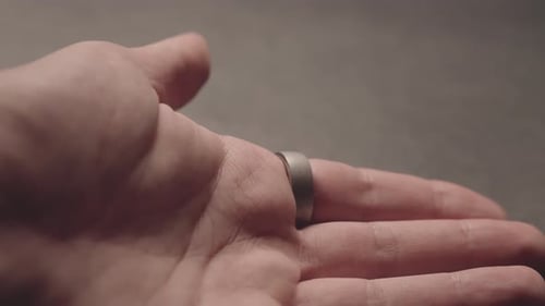 Hand Wearing a Simple Metal Band Ring