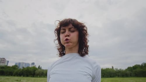 Young Slim Lady Training Outdoors Sports Woman Breathing and Waves Fast Her Arms Girl Concentration