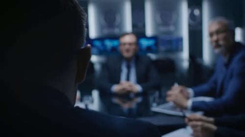 Back View shot of the Corporate Executive Debates with His Board of Directors Colleague on a Meetin