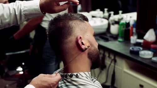 Hipster Man Client Visiting Haidresser and Hairstylist in Barber Shop Ear Hair