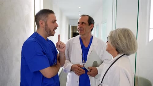 Medical team meeting in a modern hospital hallway