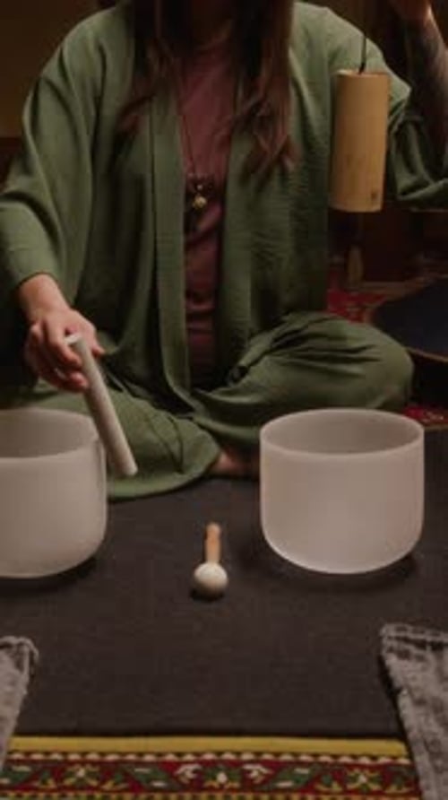 Woman Playing Crystal Bowls for Sound Healing Therapy