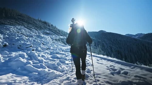 Hiker Walking On Snowy Mountain Path, Tatra Mountains In Poland