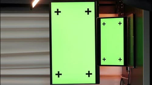 Modern digital work desk with laptop and computer with chroma key monitors. Vertical video