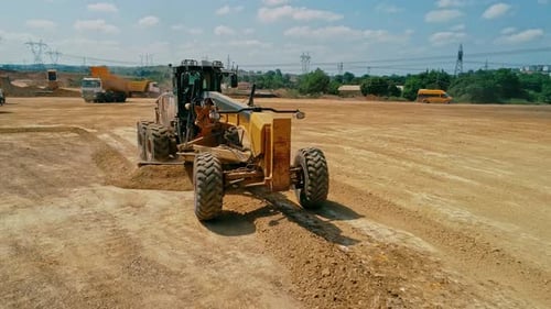 Heavy Equipment Leveling Dirt Lot During Construction