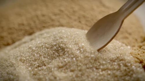 Close Up Slow Motion Shot Of Wooden Spoon Scooping Brown Sugar