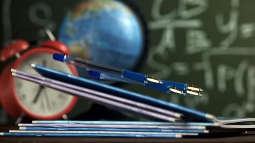 Notebooks and Pens Fall on the School Desk Filmed on a Highspeed Camera at 1000 Fps
