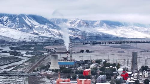 Aerial view of an oil refinery emitting steam and smoke,