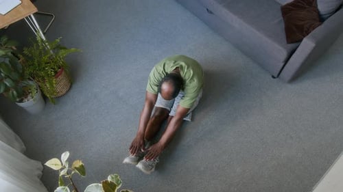 Top View of Senior Man Doing Forward Bend Exercise for Abdominal Muscles