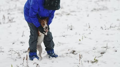 Child Embraces Dog in Snowy Winter Landscape