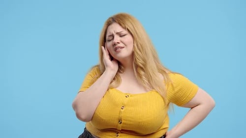Plus Size Woman with Tooth Pain Blue Background Toothache Dental Problem