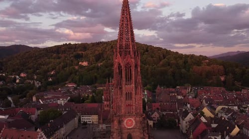 shooting from a drone, view of the Freiburg Cathedral in the direction of the hill opposite the city