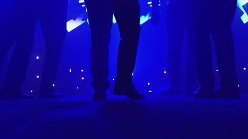 Low Angle Close Up of Formal Feet Dancing in Blue Party Light