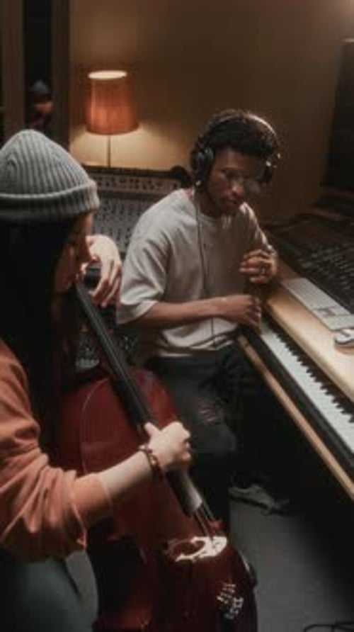 Musicians Collaborate on Music in Recording Studio