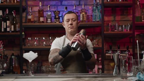 Slow Motion Video of a Bartender Shaking a Cocktail at the Bar with a Shaker
