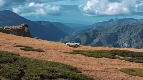 Pickup car riding off-road though the mountains