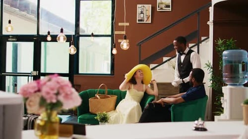 Couple Chatting With Staff in Hotel Lobby