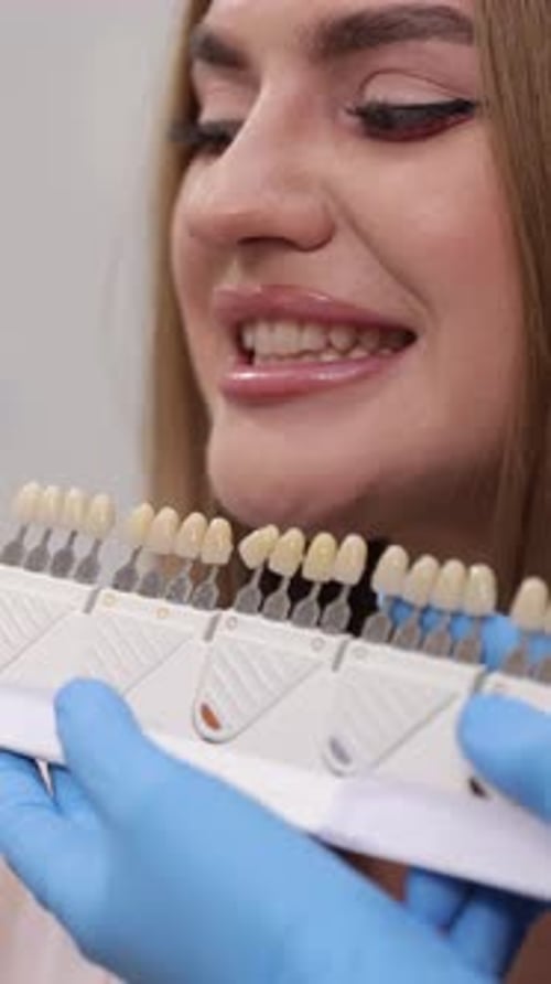 Young Woman Selecting Teeth Shade at Dentist