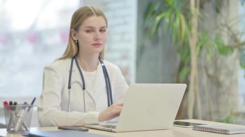 Young Doctor Working on Laptop in Office