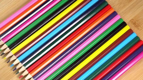 Vibrant Row of Colored Pencils on Wood