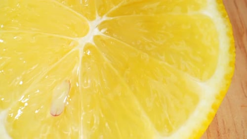 Close-Up of Juicy Lemon Half on Wood Surface