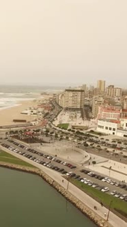 Vertical Video of Sea Waves and City Buildings